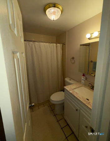 186 Seaton Road, Unit 2 Stamford, CT 06902 - Photo 4 of 14 a bathroom with a granite countertop sink toilet and shower