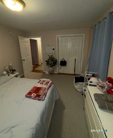 186 Seaton Road, Unit 2 Stamford, CT 06902 - Photo 6 of 14 a bedroom with bed and a mirror