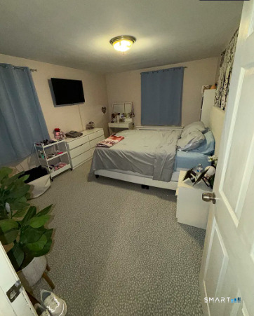 186 Seaton Road, Unit 2 Stamford, CT 06902 - Photo 8 of 14 a bedroom with a bed and a flat screen tv