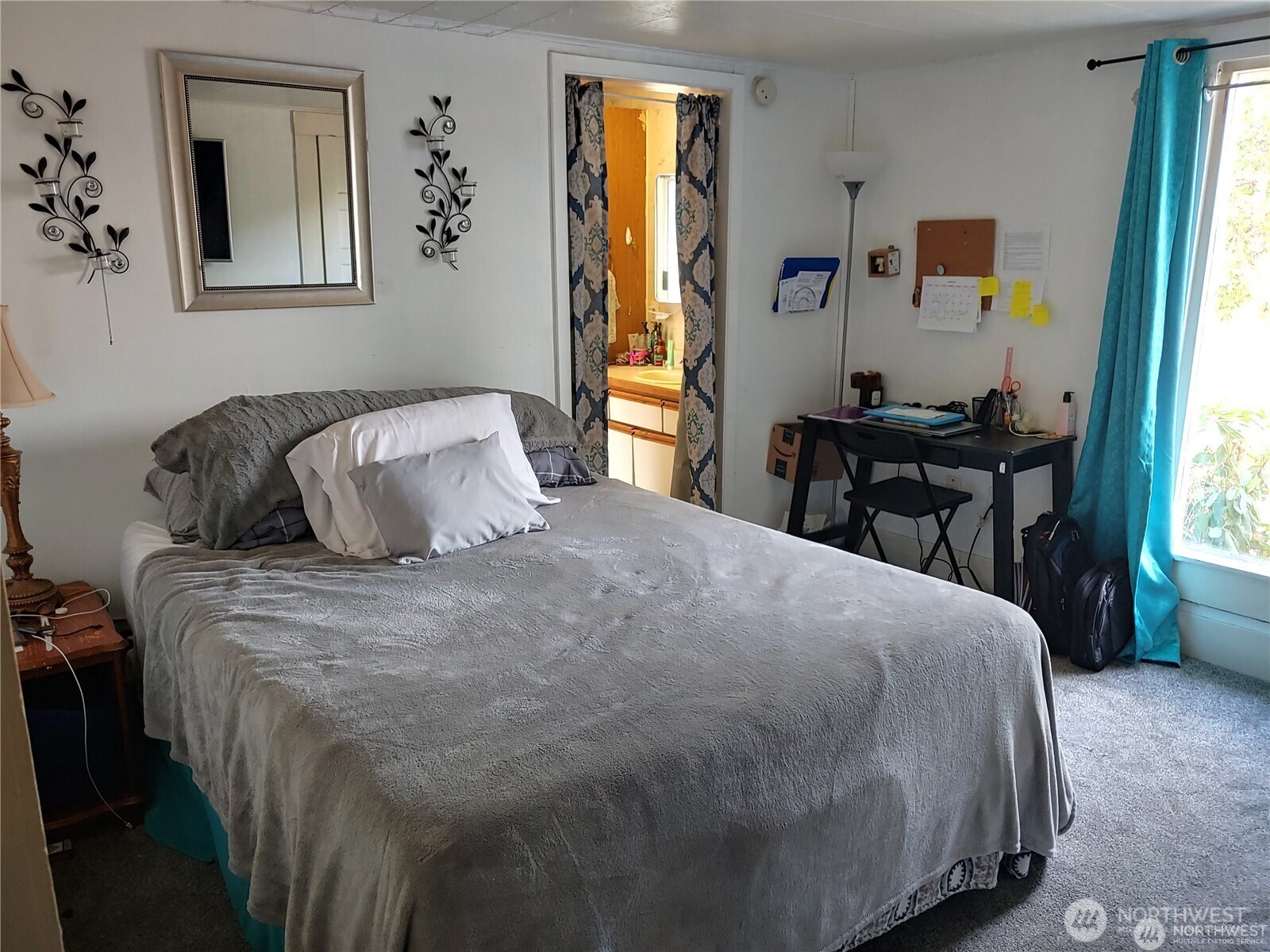 664 Rhoades Road Winlock, WA 98596 - Photo 12 of 26 a bedroom with a bed and wooden floor