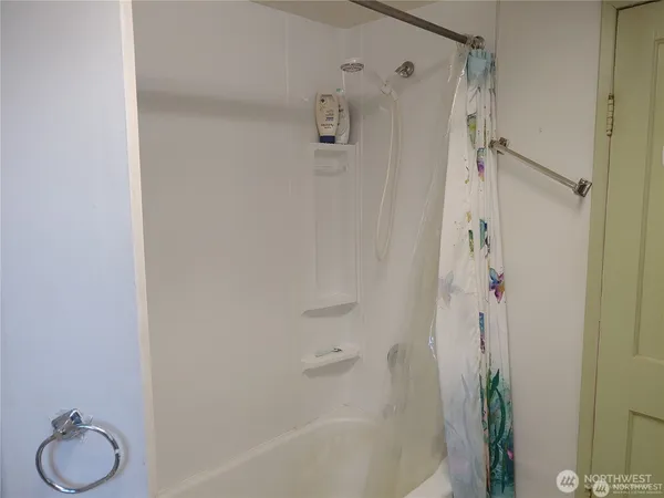 a room with furniture a ceiling fan and a window