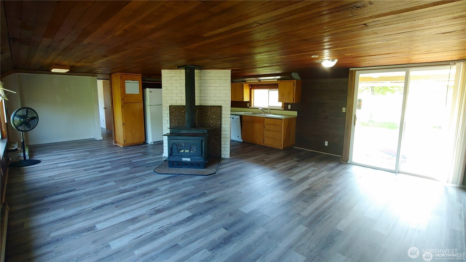 664 Rhoades Road Winlock, WA 98596 - Photo 23 of 26 a view of empty room with wooden floor and fireplace