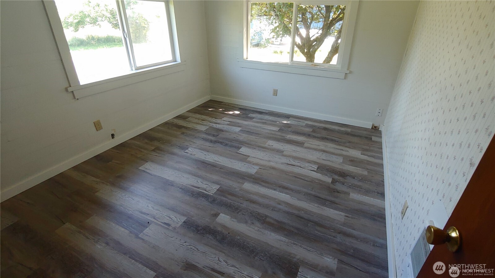 664 Rhoades Road Winlock, WA 98596 - Photo 25 of 26 an empty room with wooden floor and windows