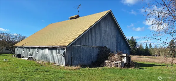 a view of backyard with potted plants and a wooden fence