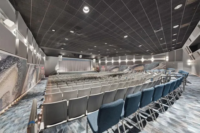 a living room with fireplace furniture and a chandelier
