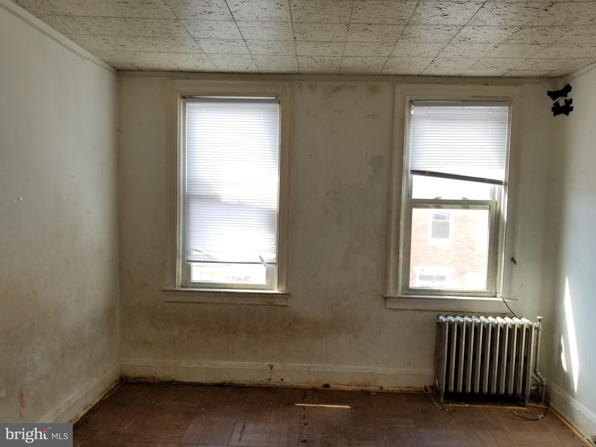 2606 Grogan Avenue Baltimore, MD 21213 - Photo 6 of 9 an empty room with a window