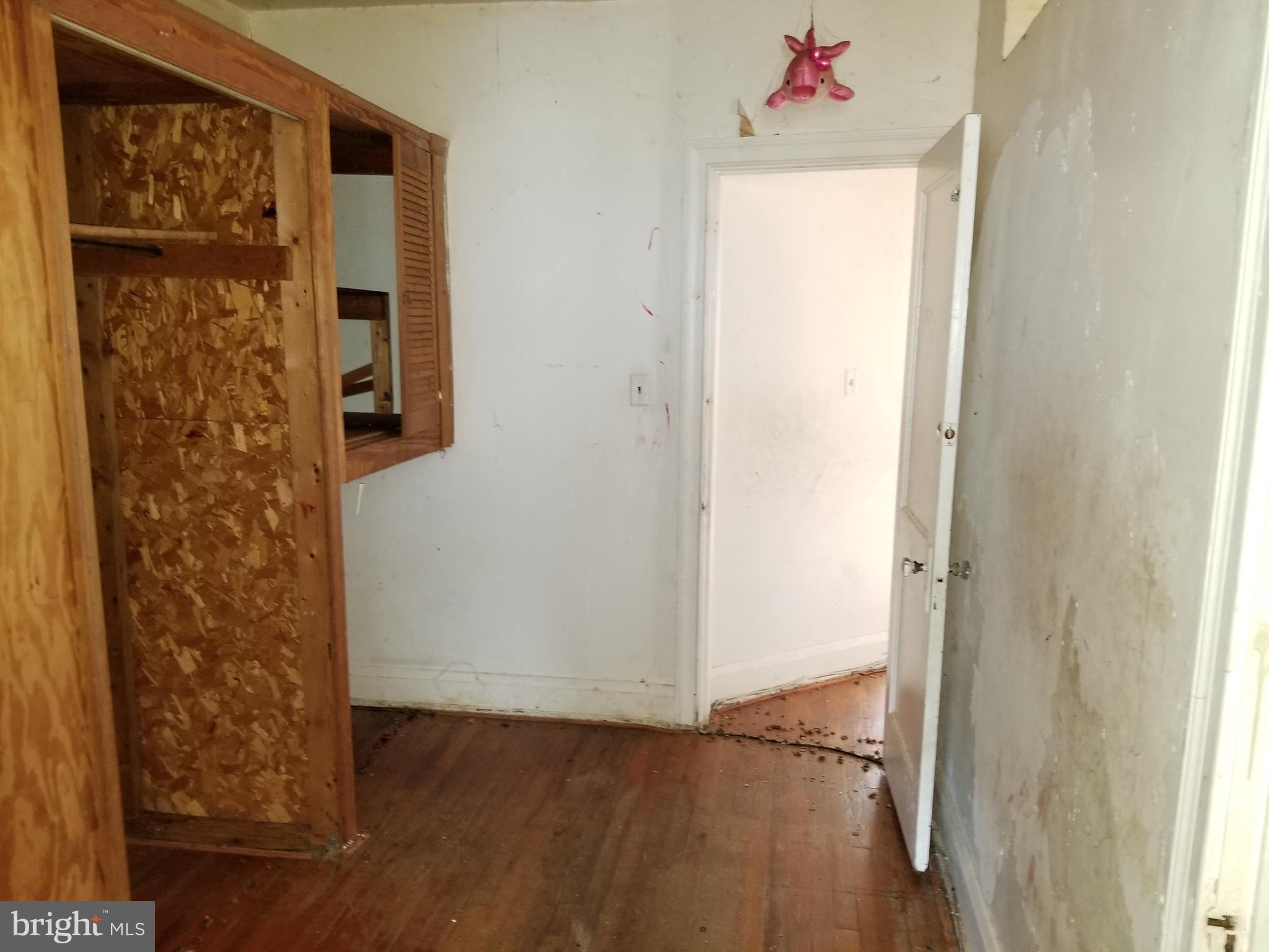 2606 Grogan Avenue Baltimore, MD 21213 - Photo 7 of 9 a view of a hallway with wooden floor and closet area
