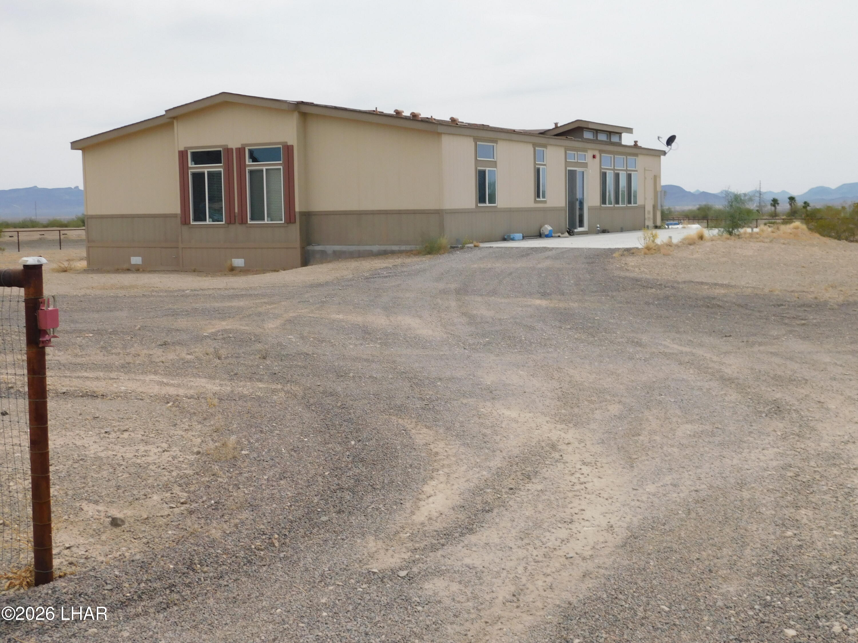 42159 Harms Way Salome, AZ 85348 - Photo 7 of 16 a front view of a house with a yard and garage