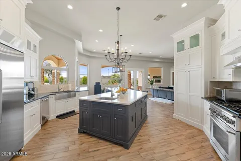 a kitchen with stainless steel appliances granite countertop a stove and cabinets