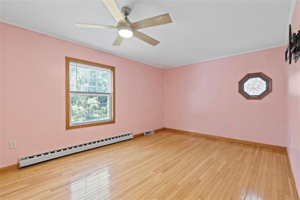 366 Claytonia Road Slippery Rock, PA 16057 - Photo 24 of 38 a view of an empty room with window and wooden floor