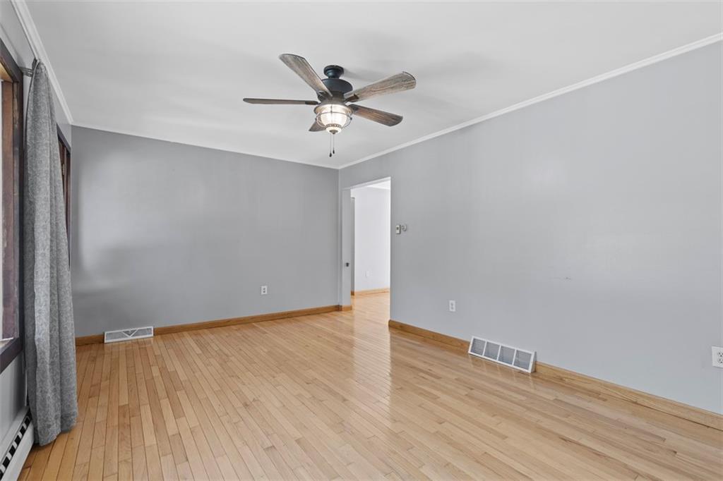 366 Claytonia Road Slippery Rock, PA 16057 - Photo 8 of 38 a view of an empty room with wooden floor and a ceiling fan