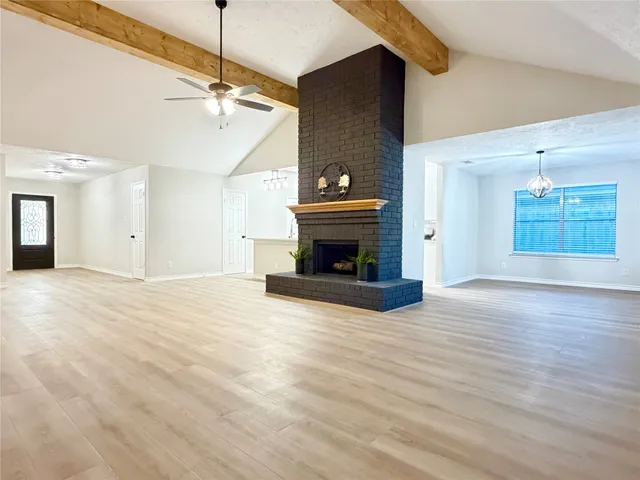 a view of a livingroom with a fireplace and window