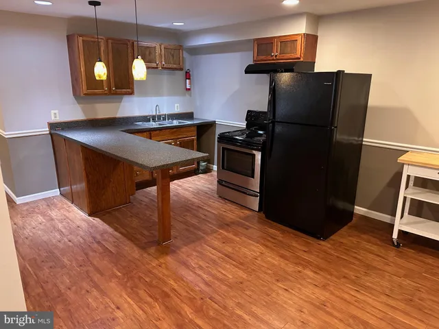 a kitchen with stainless steel appliances granite countertop a refrigerator and a stove