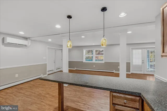 a view of a kitchen with a sink and refrigerator