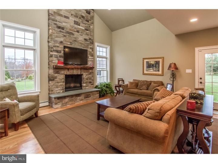 310 West Sandy Ridge Road Doylestown, PA 18901 - Photo 8 of 24 a living room with furniture a flat screen tv and a fireplace