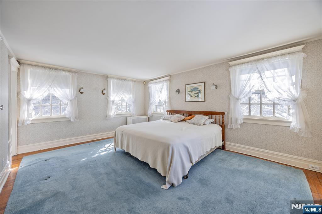 76 Forest Road Tenafly, NJ 07670 - Photo 15 of 32 a spacious bedroom with a bed and a window