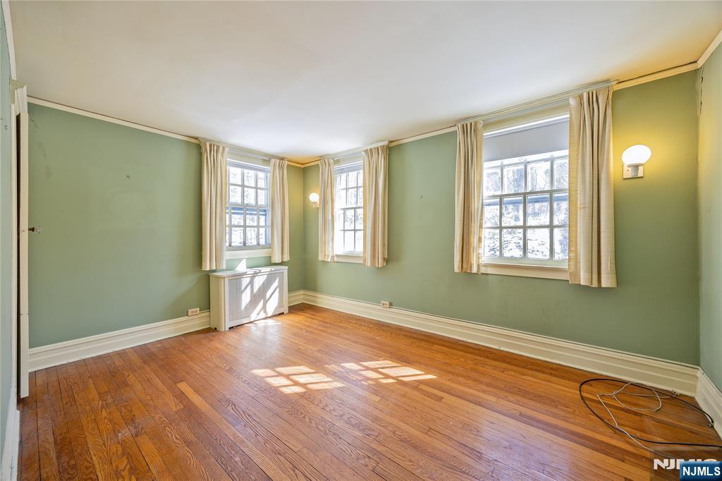 76 Forest Road Tenafly, NJ 07670 - Photo 18 of 32 a view of empty room with wooden floor and fan