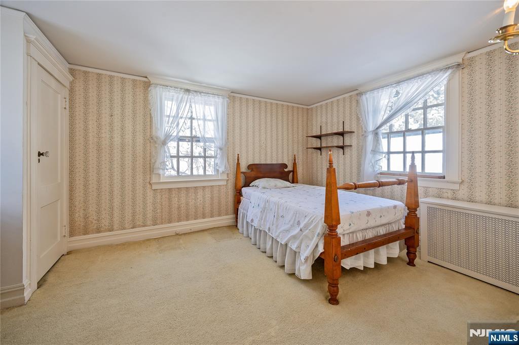76 Forest Road Tenafly, NJ 07670 - Photo 19 of 32 a bedroom with a bed lamp and window