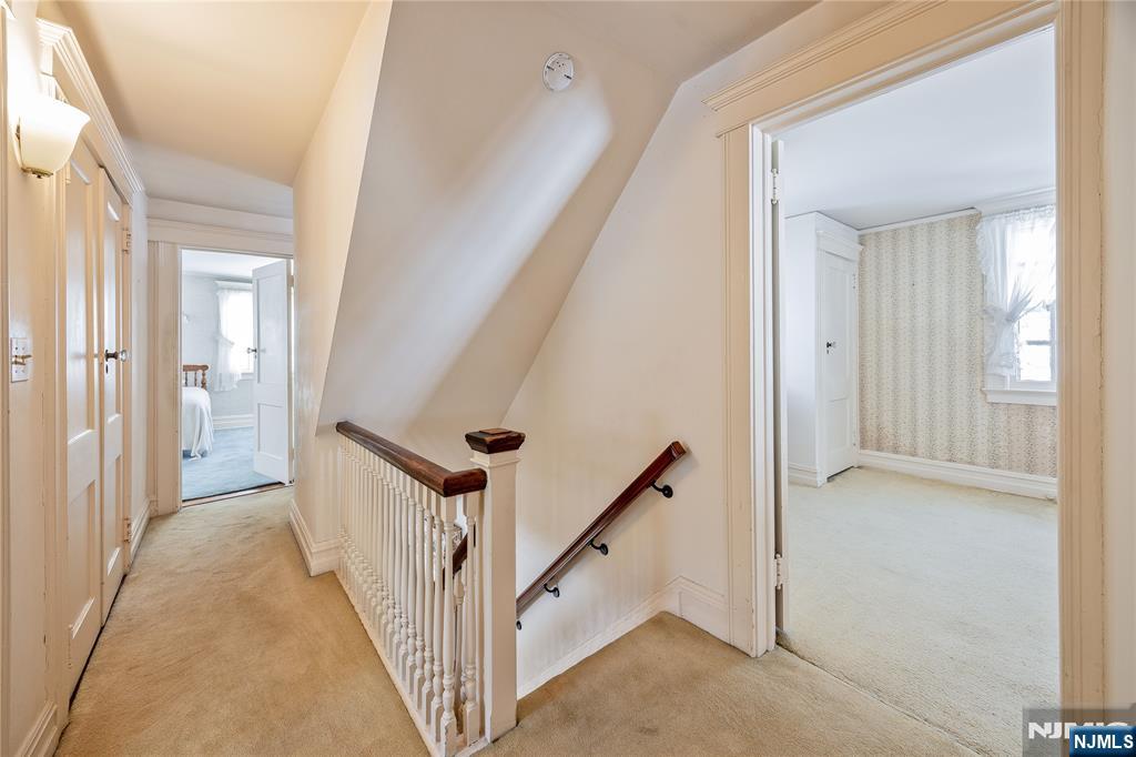 76 Forest Road Tenafly, NJ 07670 - Photo 21 of 32 a view of a hallway with white walls and stairs