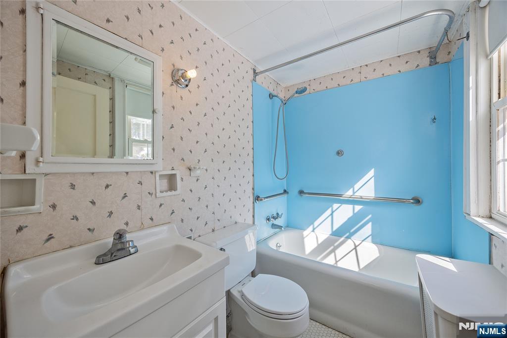 76 Forest Road Tenafly, NJ 07670 - Photo 22 of 32 a bathroom with a toilet a sink and a bathtub