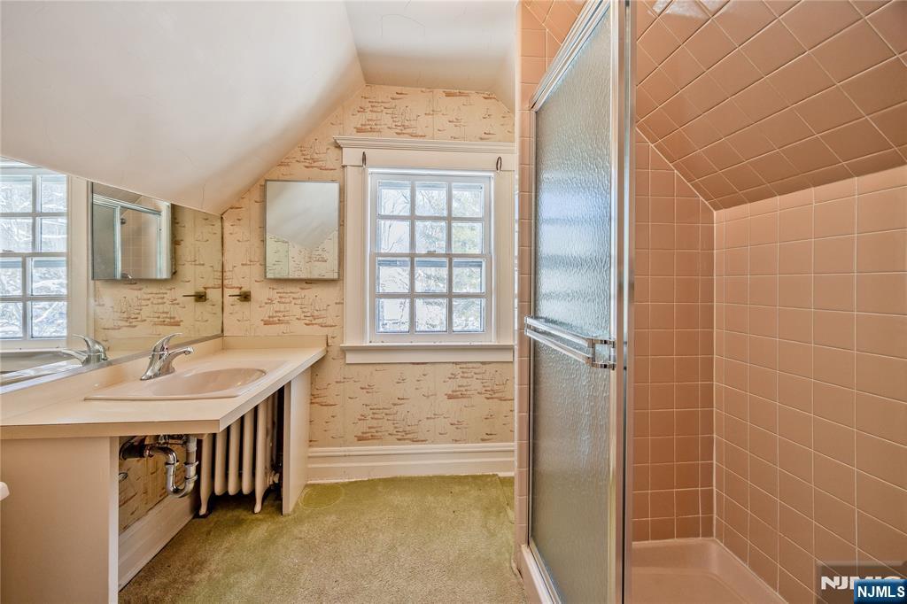 76 Forest Road Tenafly, NJ 07670 - Photo 24 of 32 a bathroom with a tub sink and mirror