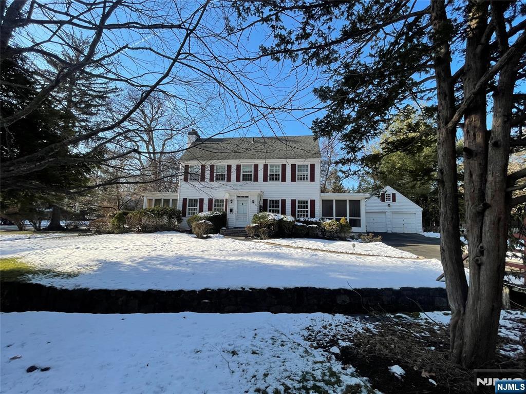 76 Forest Road Tenafly, NJ 07670 - Photo 32 of 32 a view of a house with a yard covered in snow