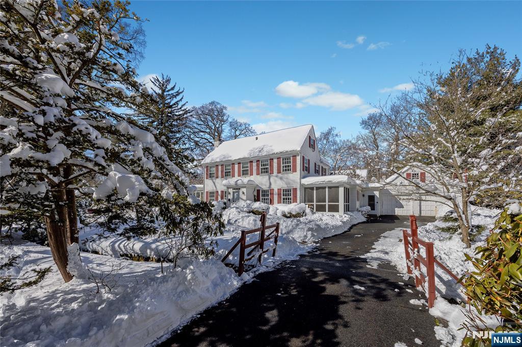 76 Forest Road Tenafly, NJ 07670 - Photo 4 of 32 a view of a blue and white house with a yard and sitting area