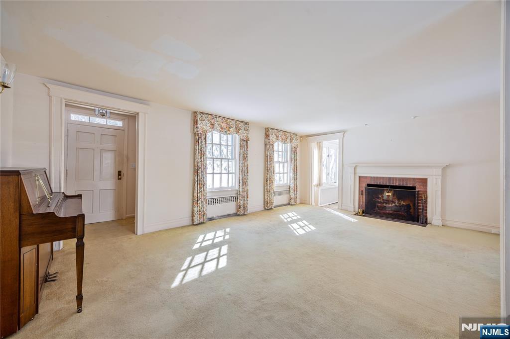 76 Forest Road Tenafly, NJ 07670 - Photo 5 of 32 a view of a livingroom with a fireplace