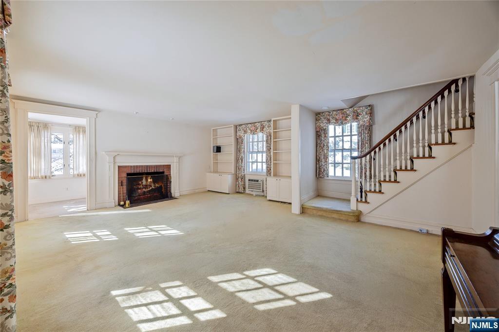 76 Forest Road Tenafly, NJ 07670 - Photo 6 of 32 a view of empty room with fireplace and windows