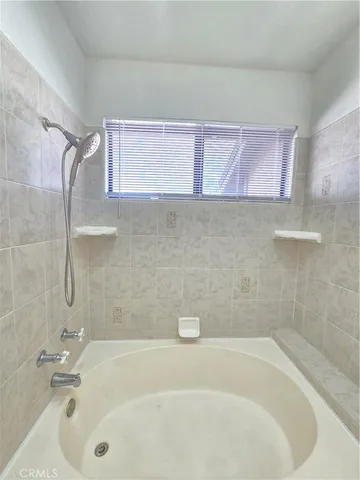 a bath tub sitting next to a white sink