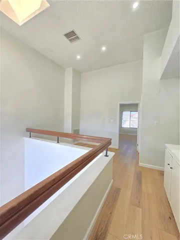 a room with wooden floor and pool table