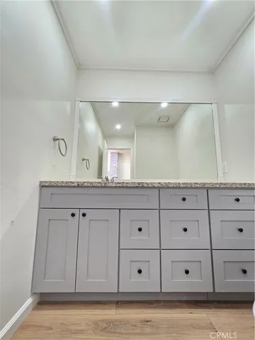 a view of a kitchen with white cabinets