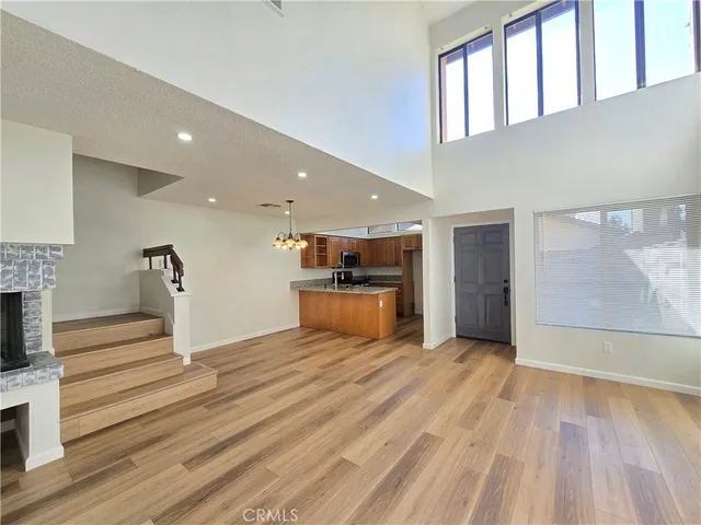 a view of a hallway with wooden floor and a fireplace