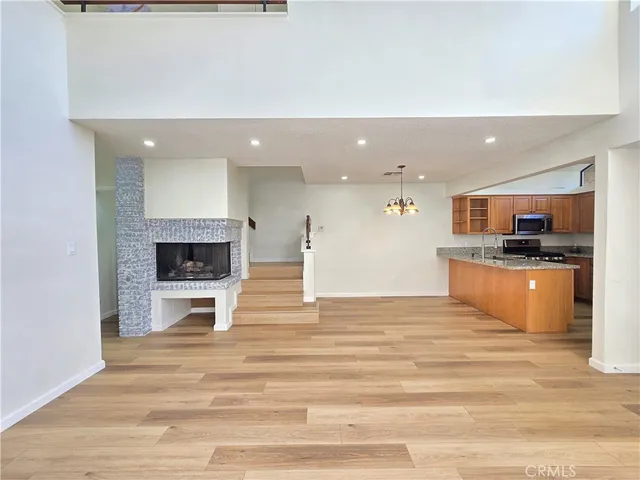 a view of kitchen with refrigerator stove microwave and cabinets
