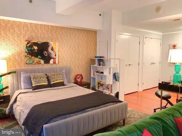 a bedroom with a bed and a chandelier