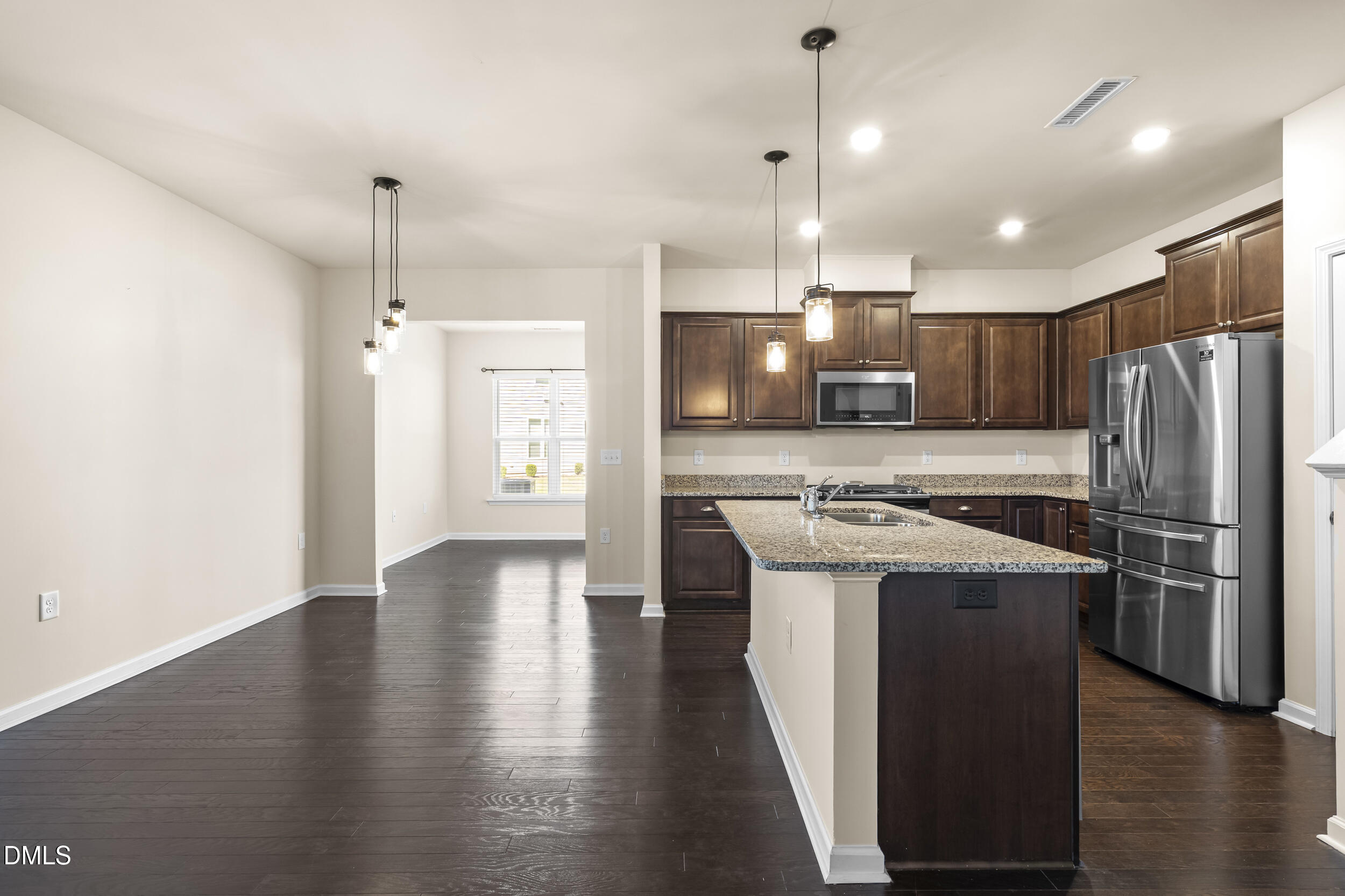 113 Lafferty Street Durham, NC 27560 - Photo 11 of 50 a view of a kitchen with a stove a refrigerator and a counter top space