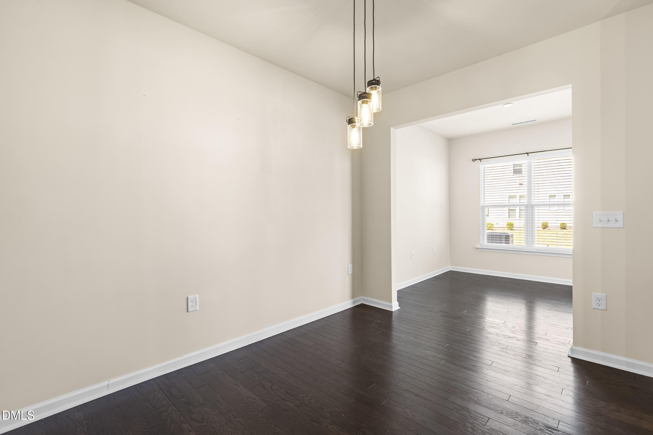 113 Lafferty Street Durham, NC 27560 - Photo 16 of 50 an empty room with wooden floor chandelier fan and windows