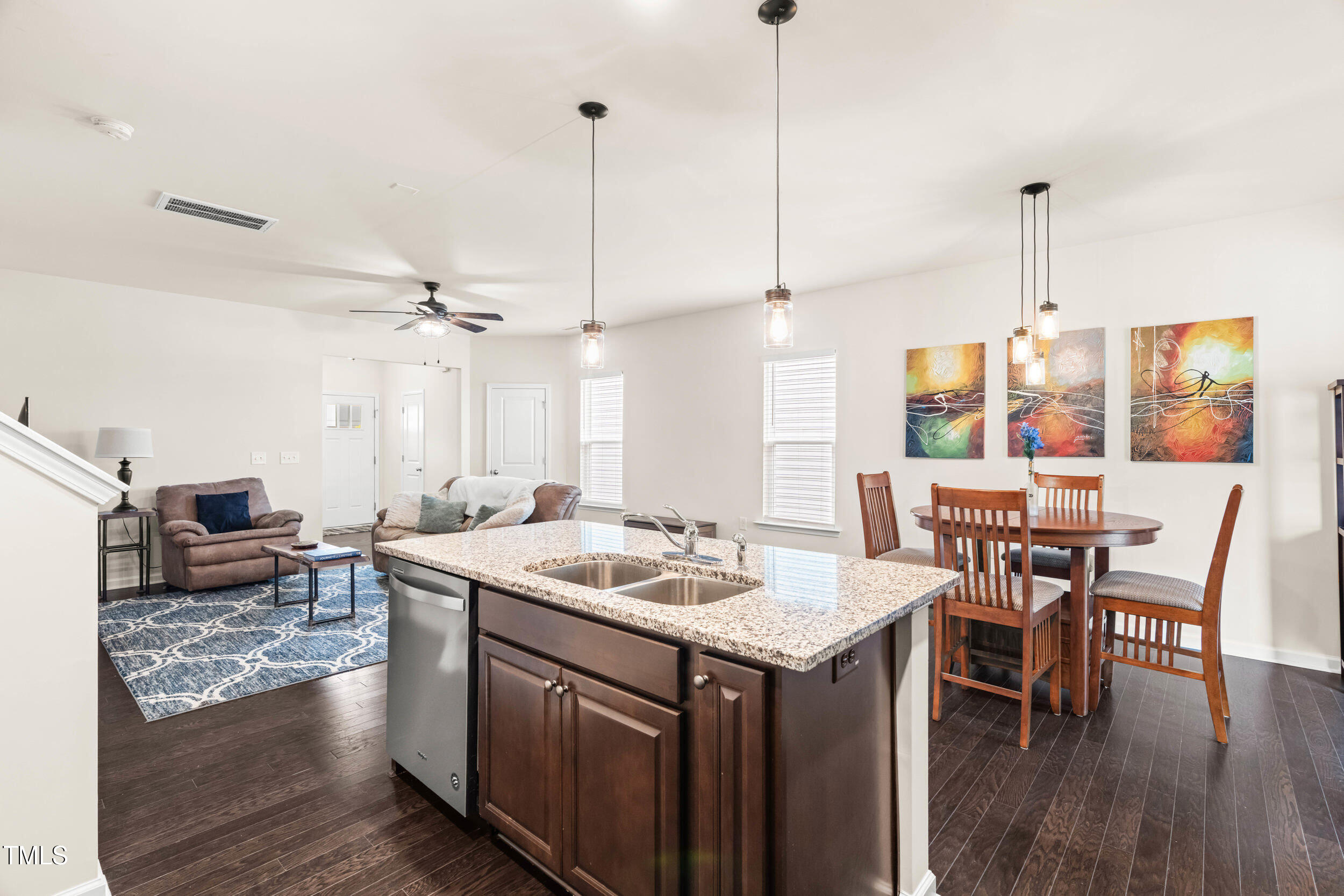 113 Lafferty Street Durham, NC 27560 - Photo 22 of 50 a kitchen that has a table chairs in it and wooden floors