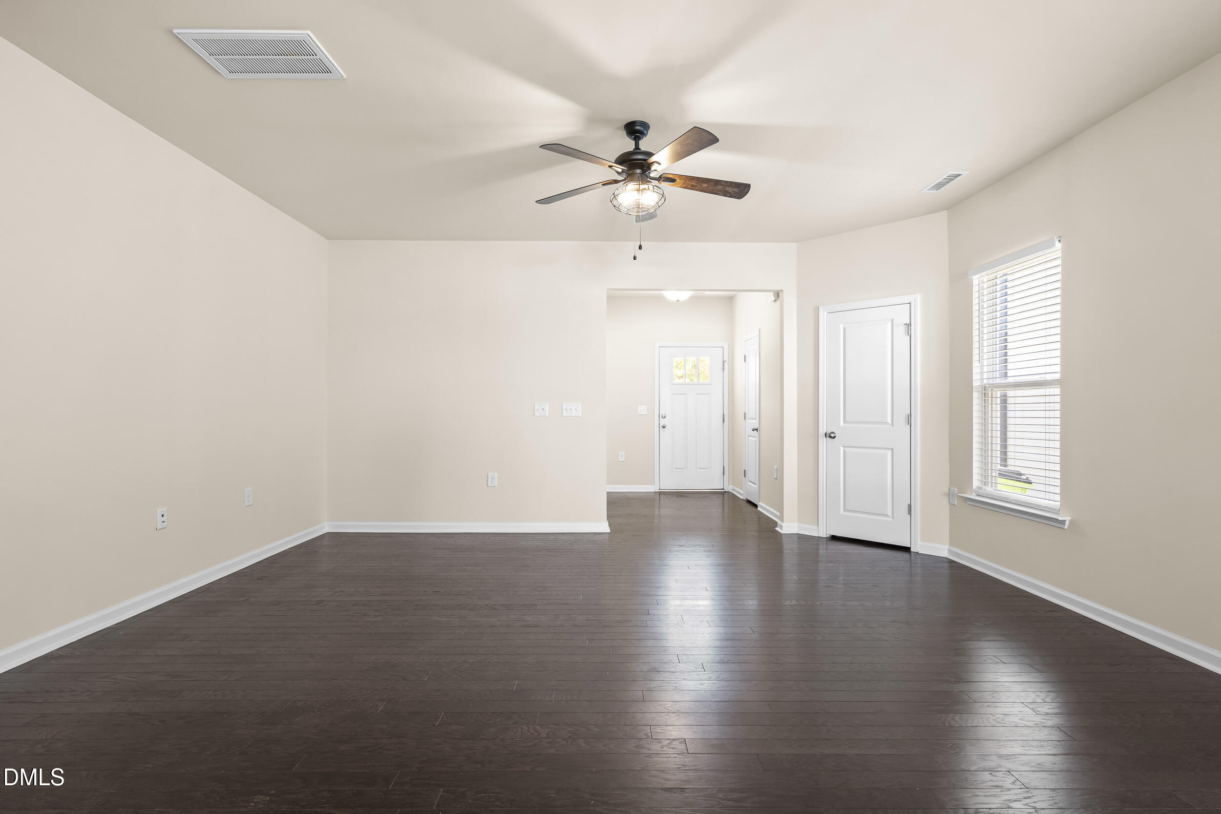 113 Lafferty Street Durham, NC 27560 - Photo 6 of 50 an empty room with wooden floor fan and windows