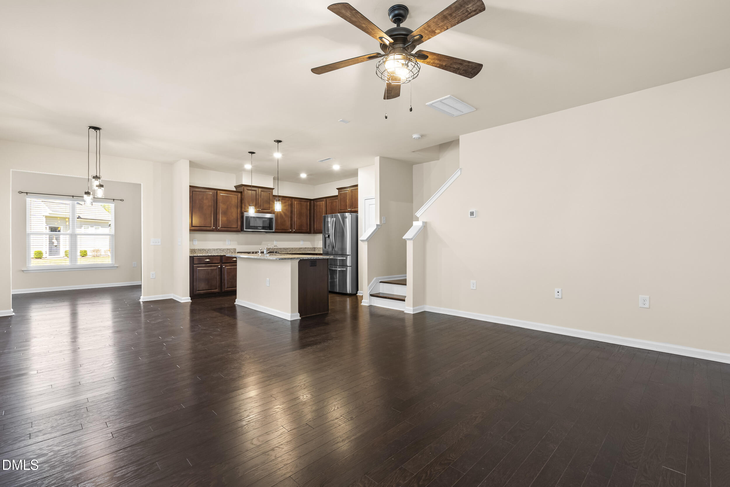 113 Lafferty Street Durham, NC 27560 - Photo 9 of 50 an open kitchen with a chandelier stainless steel appliances and a ceiling fan