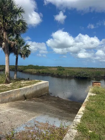 a view of a dirt yard with a street