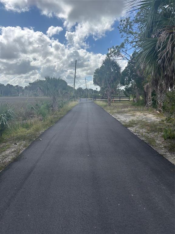 3217 Shine Lane Spring Hill, FL 34607 - Photo 6 of 19 a view of a dirt yard with a street