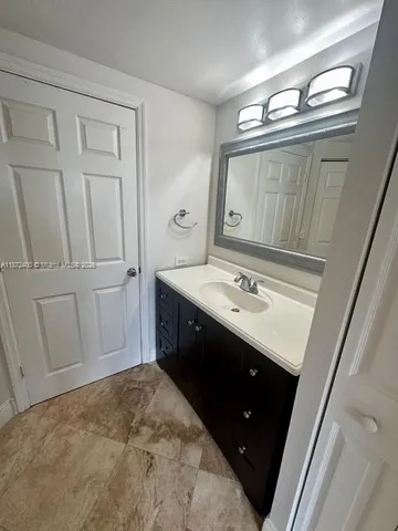 a spacious bathroom with a sink vanity and a mirror