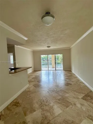 a view of a room with wooden floor and fan