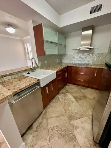 a kitchen with stainless steel appliances granite countertop a sink and a stove