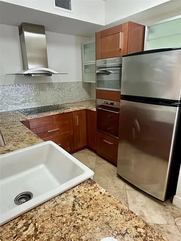 a kitchen with a refrigerator and a sink