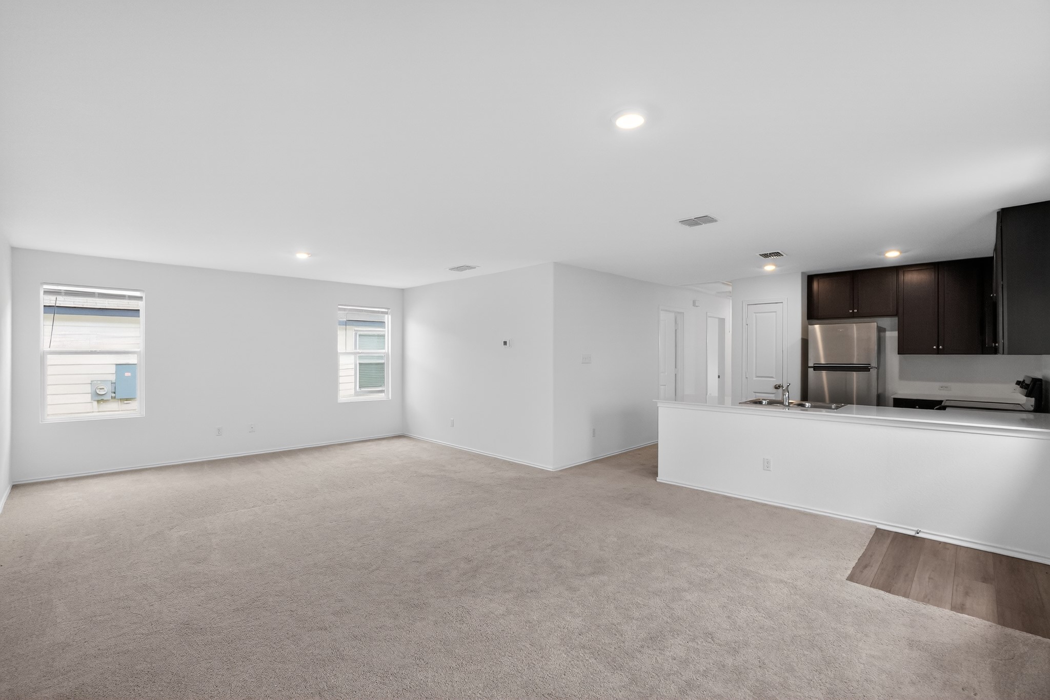 604 Marty Allen Loop Jarrell, TX 76537 - Photo 4 of 15 An open concept living area transitions effortlessly into a contemporary kitchen, creating a harmonious living space.