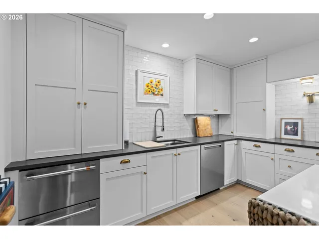 a kitchen with granite countertop cabinets stainless steel appliances and a sink