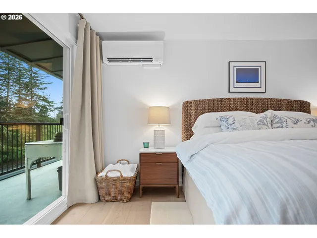 a bedroom with a bed and large window