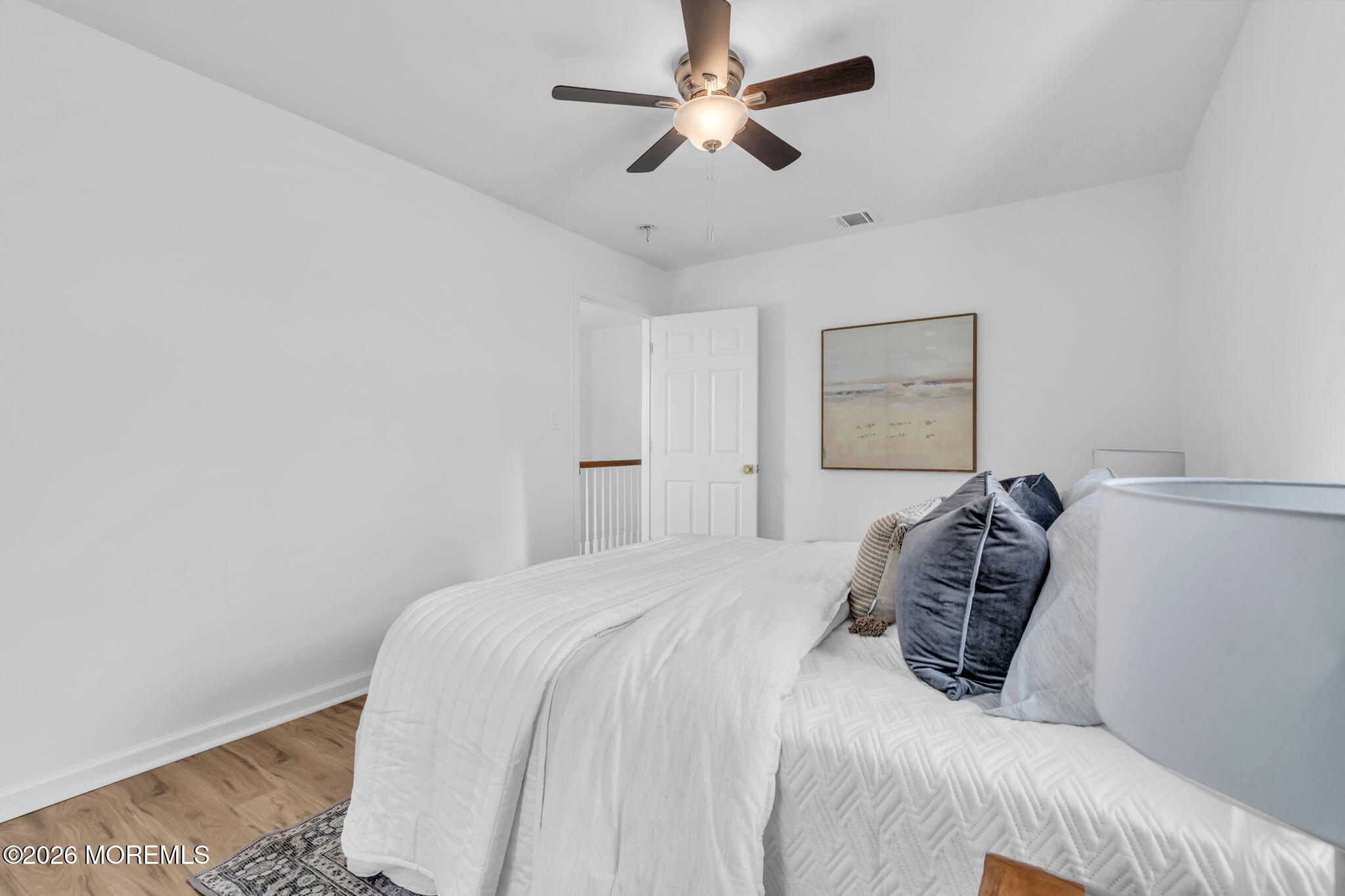13 Locust Street Highlands, NJ 07732 - Photo 12 of 42 a bedroom with a bed and a painting on the wall